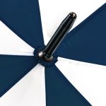 Close-up of a navy and white X-brella umbrella with a black handle.